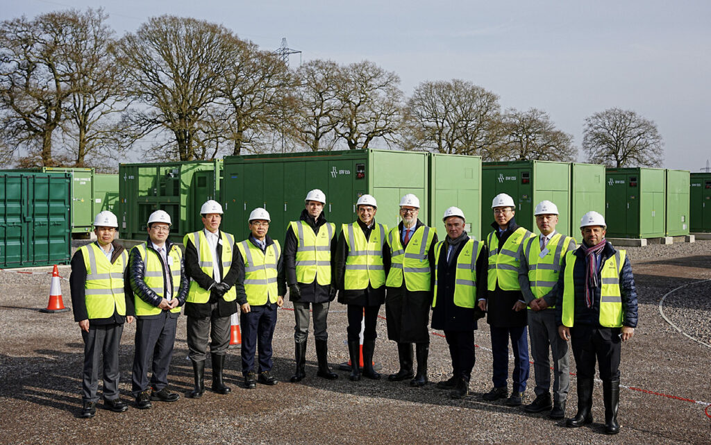 People in hard hats and high vis vests at a battery project.