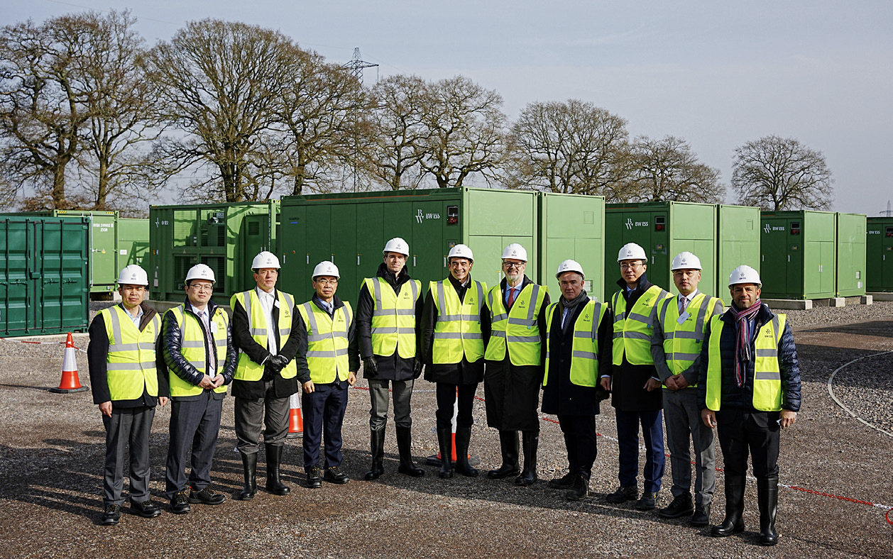 People in hard hats and high vis vests at a battery project.
