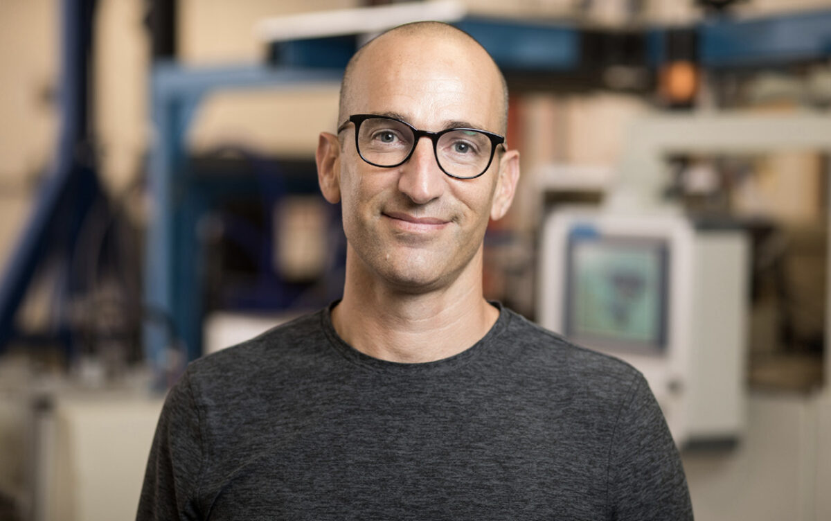 A man with glasses pictured inside a laboratory.
